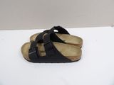 black birkett sandals on a white surface with a white background