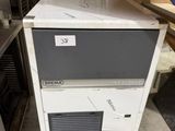 a small ice machine sitting on top of a counter