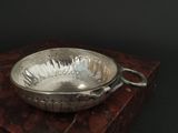 a silver bowl sitting on top of a wooden box
