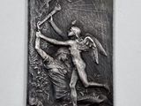 an image of a metal plaque depicting a man with a bow and arrow