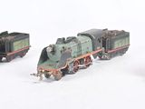 four toy trains that are lined up on a white surface