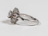 a ring with a flower design on it on a white surface