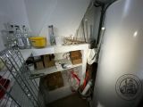 an image of a kitchen with a refrigerator and a lot of clutter