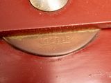 a close up of a red suitcase with a metal handle