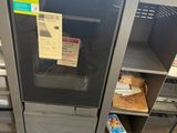 an image of a microwave in a store with a lot of boxes