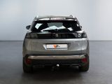 the rear end of a silver suv parked in a white room
