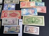several different types of foreign currency are displayed on a table