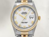 a rolex watch with roman numerals and a white dial