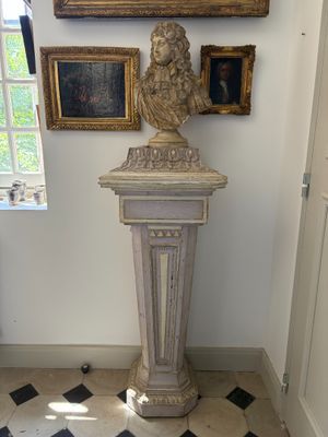 a statue of a man on a pedestal in a room