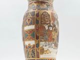 a vase with a picture of a woman and a man on it