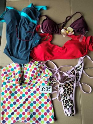 a group of swimsuits laid out on the floor next to each other