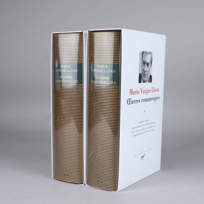 the two books are sitting side by side on the table