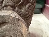 a close up of a stone pillar with a design on it