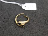 a close up of a gold ring with a black stone on it