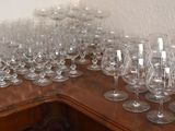 a lot of wine glasses sitting on a wooden table