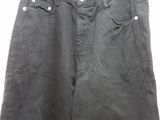 the back of a pair of black pants hanging on a hanger