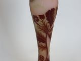 a glass vase with a design on it on a black base