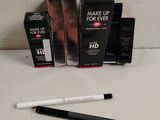 a close up of a box of makeup and a pen on a table