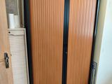a wooden door with a black handle in a room