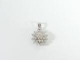 a close up of a diamond pendant on a white surface