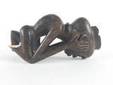sculpture of a woman laying on her back on a white surface