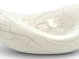 a white bowl with a pattern on it on a white surface