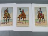 three cards of soldiers riding on horses on a gray surface