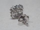 a pair of earrings that are sitting on a table