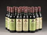 six bottles of wine are lined up in a row on a table