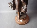 a statue of a woman holding a bird on a pedestal