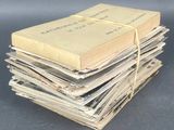 several old books stacked on top of each other on a table