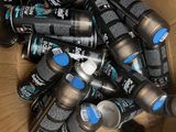 a cardboard box full of cans of black and blue paint