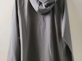 an image of a gray jacket hanging on a wall