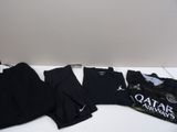 a lot of clothes that are sitting on a table