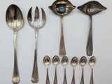 several spoons and spoon spoons are lined up on a white surface