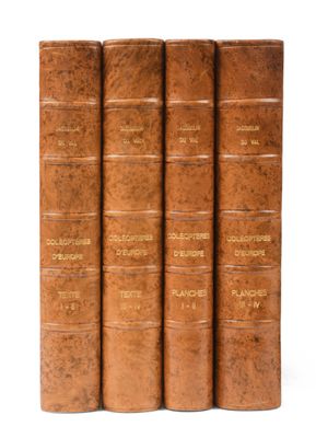 a set of four old books sitting on top of each other