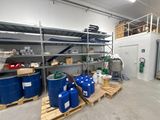 a room with a lot of blue barrels and pallets