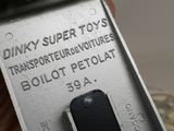 a close up of a metal object with the words dinky super toys on it