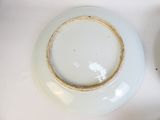 a white plate with a gold rim sitting on a table