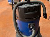 a vacuum that is sitting on the floor in the room