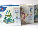 three boxes of magnetic construction toys sitting next to each other