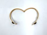 a gold cuff with a heart shaped design on it