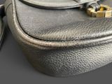 a close up of a black purse with a gold clasp