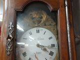 a grandfather clock with roman numerals on the face