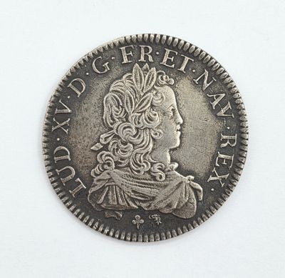 une vieille pièce d'argent sur laquelle figure la tête d'une femme coiffée d'une couronne