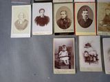a lot of old photos of people sitting on a table