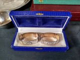 two silver cuff bracelets in a blue box on a table