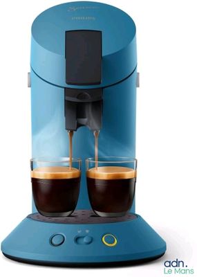 a blue coffee machine with two cups of coffee on it