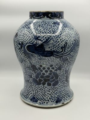 a blue and white vase with a bird on it