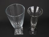 two wine glasses sitting next to each other on a table